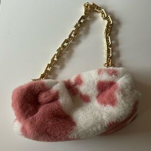 pink and white plush cow print bag